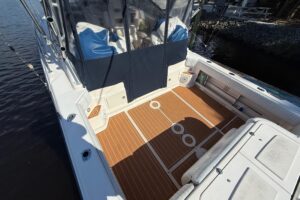Grady-White Express 330 center console helm station with dual Garmin displays and steering wheel.