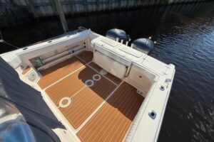 Grady-White Express 330 helm station with dual Garmin displays and center console steering wheel.