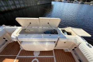 Grady-White Express 330 helm station with dual Garmin displays and center console steering wheel.