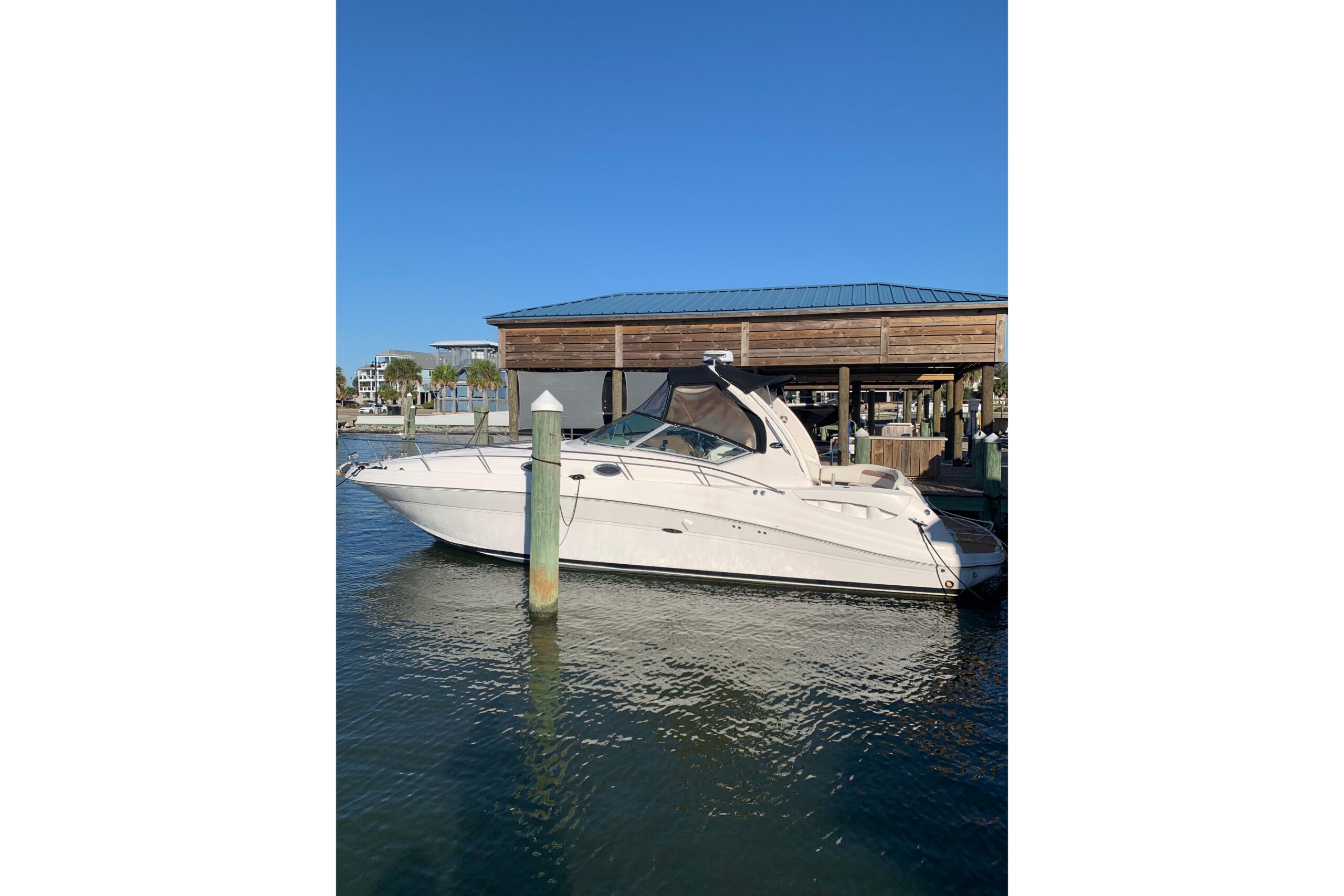 2005 Sea Ray 340 Sundancer 37.5-foot cruiser with white hull and hardtop profile viewed from starboard side in Pass Christ...