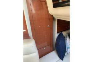 2005 Sea Ray 340 Sundancer salon with curved seating, entertainment center, and cabin access.