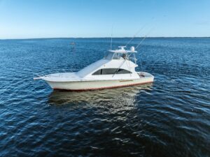 Bow view of 2006 Ocean 57 motor yacht with white hull and hardtop, anchored in Manteo, North Carolina.