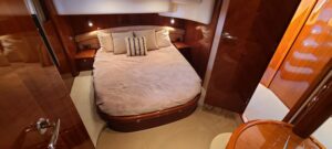 Viking Princess 61 Flybridge flybridge helm station with dual helm chairs, steering wheel, and panoramic windshield overlo...