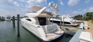 Viking Princess 61 Flybridge flybridge helm station with dual helm chairs, steering wheel, and instrument displays overloo...