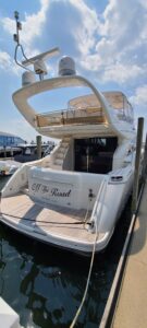 Viking Princess 61 Flybridge flybridge helm station with dual helm seats, steering wheel, and instrument panel overlooking...