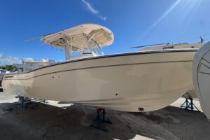 2007 Grady-White Bimini 306 center console with hardtop and helm seating viewed from starboard side.