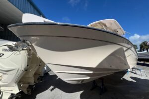 2007 Grady-White Bimini 306 center console helm station with dual Garmin displays and steering wheel.