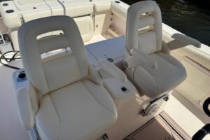 2007 Grady-White Bimini 306 center console helm station with dual Garmin displays and steering wheel.