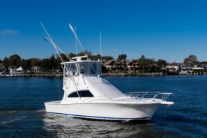 2007 Luhrs 36 Convertible sport fishing yacht with twin outboard engines and hardtop, moored at Point Pleasant, New Jersey.