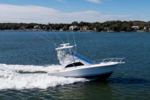 Bow view of 2007 Luhrs 36 Convertible with forward seating and windshield, anchored in Point Pleasant, New Jersey.