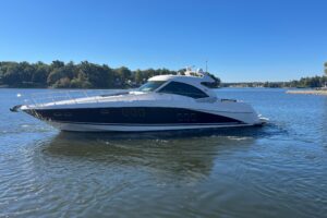 2007 Sea Ray 60 Sundancer salon with curved seating, entertainment center, and natural cabin lighting.