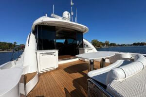 2007 Sea Ray 60 Sundancer salon with cream upholstery, entertainment center, and natural light from cabin windows.