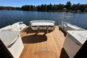 2007 Sea Ray 60 Sundancer salon with curved seating, entertainment center, and large windows overlooking the water.