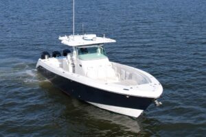 Helm station of 2008 Everglades 350 center console with dual Garmin displays, steering wheel, and overhead hardtop protect...