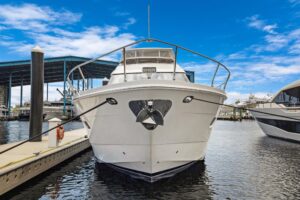 Stern view of 2008 Marquis 65 motor yacht showing transom, swim platform, and teak cockpit seating in Fort Lauderdale.