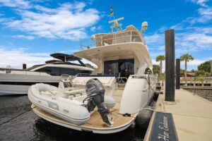 2008 Marquis 65 motor yacht salon with cream upholstery, entertainment center, and large windows overlooking the deck.