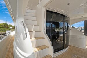2008 Marquis 65 motor yacht salon with cream upholstered seating, teak accents, and large windows providing natural light.