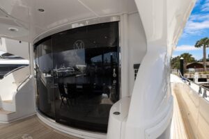 2008 Marquis 65 luxury motor yacht salon with cream upholstered seating, teak accents, and large windows providing natural...