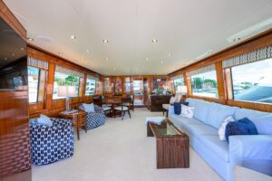 72-foot Hatteras Enclosed Bridge yacht bow section with forward seating and windshield viewed from starboard side in Key L...