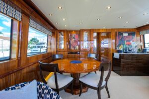 72-foot Hatteras Enclosed Bridge yacht with enclosed flybridge helm station and radar arch viewed from starboard side.