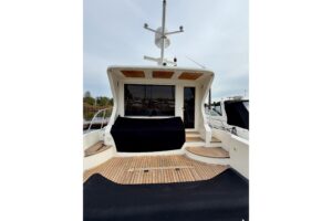 2009 Navigator Californian 50 Veneti salon with curved seating, entertainment center, and natural cabin lighting.