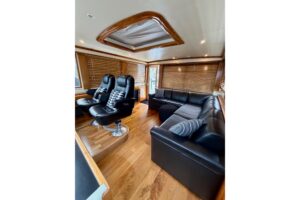 2009 Navigator Californian 50 Veneti salon with curved seating, entertainment center, and natural cabin lighting.