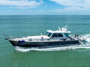 2009 Sabre 52 Express cruising yacht exterior profile showing full-length starboard side with twin towers and hardtop design.