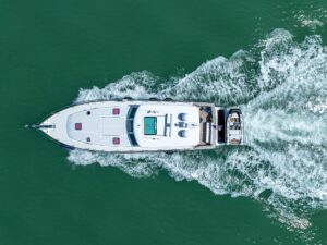 Sabre 52 Express helm station with dual Garmin displays, leather helm chair, and forward salon visibility through windshield.