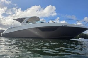 2010 Sea Ray Sundancer 370 salon with curved seating, upholstered furnishings, and cabin windows overlooking the water.