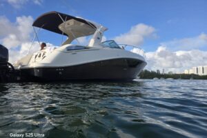 Sea Ray Sundancer 370 cabin cruiser helm station with dual Garmin displays, leather helm chair, and windshield forward vis...