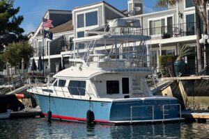 2012 Mikelson 43 Sportfisher 48-foot center console helm station with dual Garmin displays, leather seating, and hardtop o...