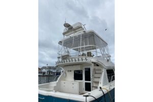 2012 Mikelson 43 Sportfisher 48-foot center console helm station with dual Garmin displays, steering wheel, and throttle c...
