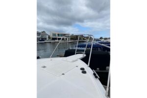 2012 Mikelson 43 Sportfisher helm station with dual Garmin displays, leather helm seat, and center console steering wheel ...