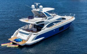 2013 Azimut 64 flybridge with helm station, hardtop, and forward seating overlooking the bow.