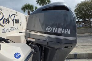 Grady-White Express 330 helm station with center console, dual Garmin displays, steering wheel, and windscreen viewed from...