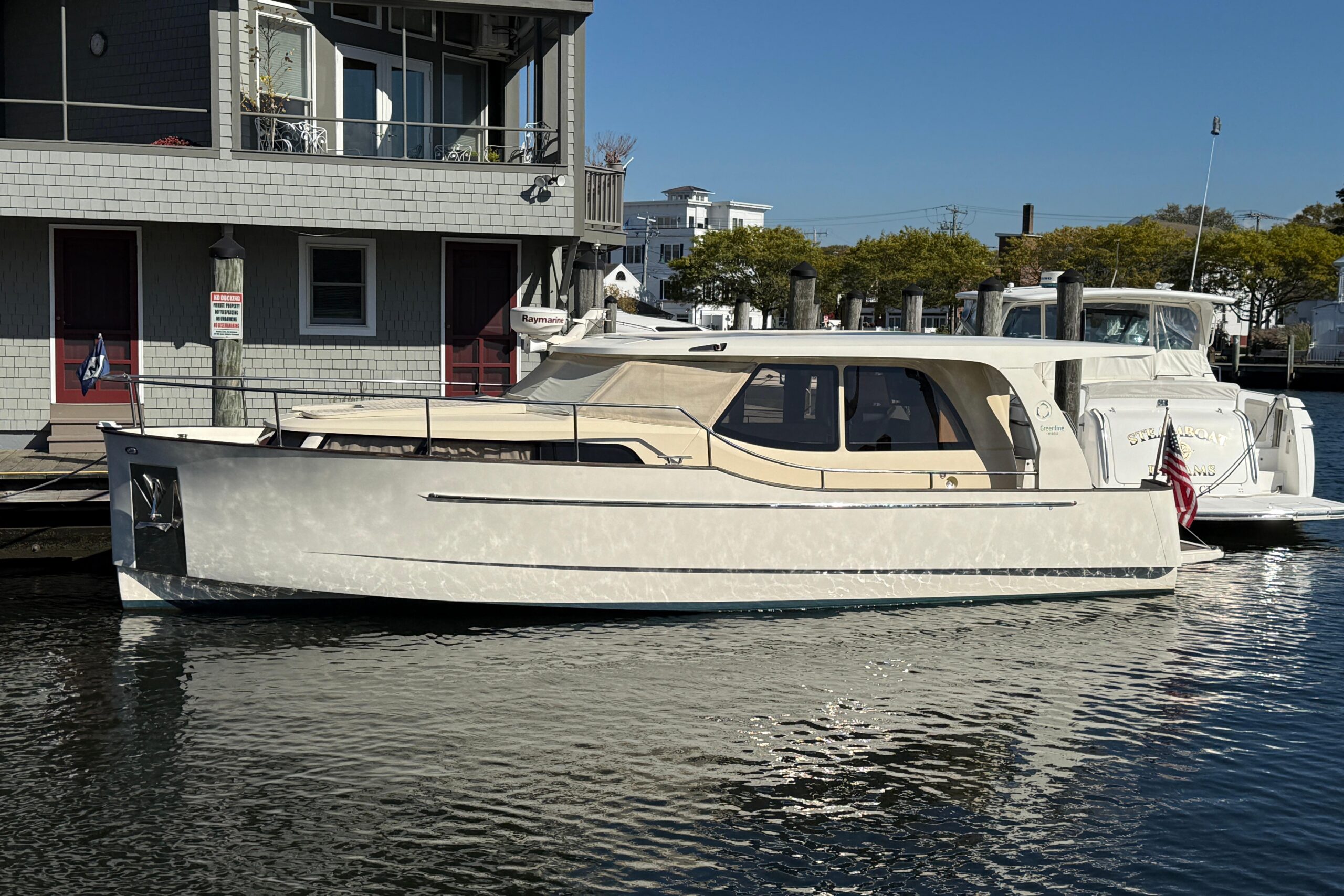2013 Greenline 33 hybrid motor yacht starboard profile showing full exterior with hardtop, teak rails, and dual helm stati...