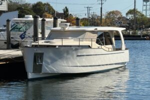 Greenline 33 hybrid yacht bow section with forward seating and cabin entry on Mystic waterfront