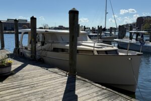 Greenline 33 hybrid yacht bow section with forward seating and cabin entry on calm water.