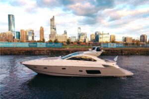 Sunseeker Predator 60 salon with cream upholstered seating, entertainment center, and natural lighting from large windows.