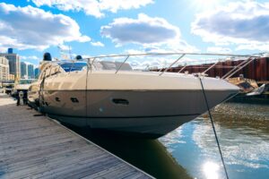 Sunseeker Predator 60 salon with cream upholstered seating, dark wood cabinetry, and large windows providing natural light.