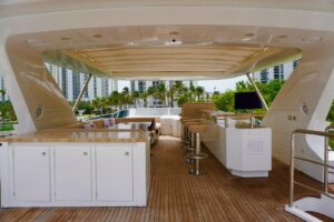 Bow view of 2015 Azimut 84 luxury motor yacht with teak foredeck and forward seating area in Aventura, Florida.