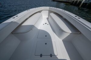 Bahama 41 center console boat with hardtop and tower, bow seating area with cushioned helm and forward cabin entry visible.