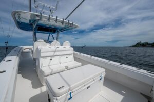 Bahama 41 center console helm station with dual Garmin displays, steering wheel, and throttle controls overlooking the bow.