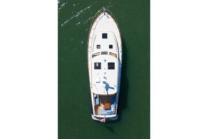 Hinckley Talaria 43 helm station with dual Garmin displays, leather helm chair, and teak accents in Charleston, SC.