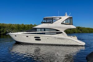 2015 Meridian 441 Sedan salon with upholstered seating, entertainment center, and cabin lighting in Fort Myers.