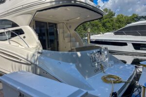 Meridian 441 Sedan salon with cream upholstered seating, teak accents, and large windows providing natural light.