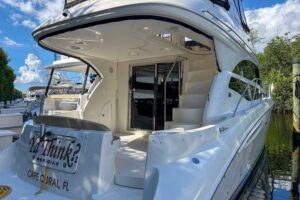 2015 Meridian 441 Sedan salon with curved settee seating, entertainment center, and cabin entry in Fort Myers.