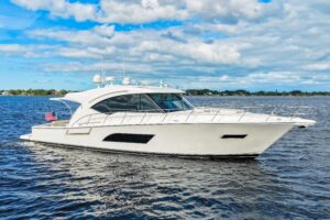 Riviera 565 SUV helm station with dual Garmin displays, leather helm chair, and forward salon visibility through windshield.