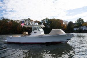 2016 Hunt Yachts 32 center console helm station with dual Garmin displays, steering wheel, and throttle controls.