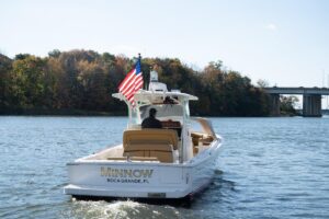 Helm station of 2016 Hunt Yachts 32 center console with dual Garmin displays, steering wheel, and throttle controls.
